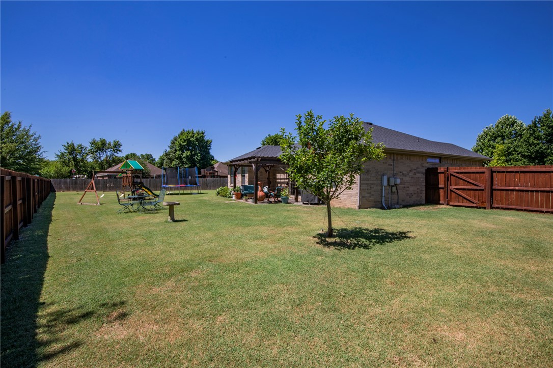 Welcome to this beautifully updated 3-bedroom, 2-bath, single-story home with a 2-car garage, perfectly blending comfort and convenience. This split-level layout offers a spacious and open feel, highlighted by new flooring throughout. The heart of the home features a cozy living area with a fireplace, perfect for relaxing evenings.  The kitchen comes equipped with a sleek gas stove and flows seamlessly into a dedicated dining room ideal for family meals and gatherings. Large sliding doors lead you to a generous backyard with a pergola, perfect for outdoor entertaining or enjoying peaceful mornings. Yard Maintenance Included.