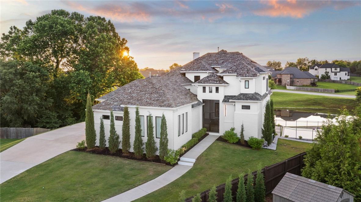 If you are looking for a home that will truly WOW you, this is it! Designed with both connection and space in mind, this 5 bed 5.5 bath home offers multiple living areas across all levels, creating the perfect balance for gathering and privacy. The main level features a spacious living area, half bath for guests, a private primary retreat, and an additional suite with its own entry, ideal for guests or multi generational living. Upstairs offers 2 BD/ 2BA and a flexible bonus space, while the walkout basement creates the ultimate hangout with a full bar, gym area, bed, and bath. Step outside to a resort style setting complete with a stunning infinity edge pool overlooking the water and multiple patios designed for hosting, relaxing, and enjoying the view. Don't miss the workshop area/garage! Thoughtfully laid out and full of possibility, this home is built for the way people truly live, in one of the area’s most desirable locations just minutes from Rogers/Pinnacle, and less than 20 minutes to Downtown Bentonville.