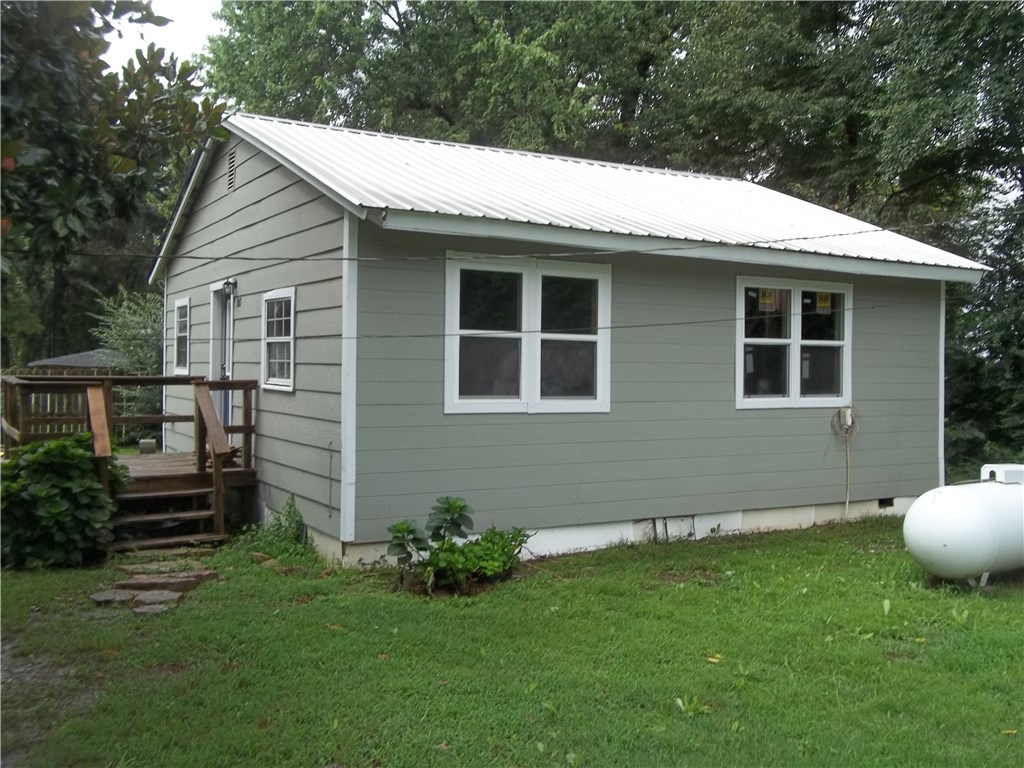 Lots of recent updates to this 2BD / 1BA adorable rustic home! Updates include New windows, cabinets, counter tops, appliances, plumbing, electric, paint and new tile floors in the kitchen& bathroom! The original hardwood floors have been re-stained and look gorgeous! Home sits on a nice level lot, with a good location just outside of city limits!