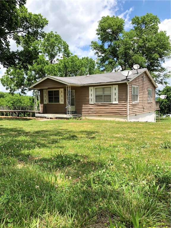 Secluded and rural setting with gorgeous views! This property sits on over 5 acres with lots of potential! Cleared land with surrounding woods creates the perfect setting. Home on property has 2 bedroom and 1 bathroom with 1100 sq ft. Lots of potential in this home. Large deck for enjoying the views. Wood deck set up for mobile home spot. Excellent property for enjoying the beautiful NWA scenery and a perfect retreat.