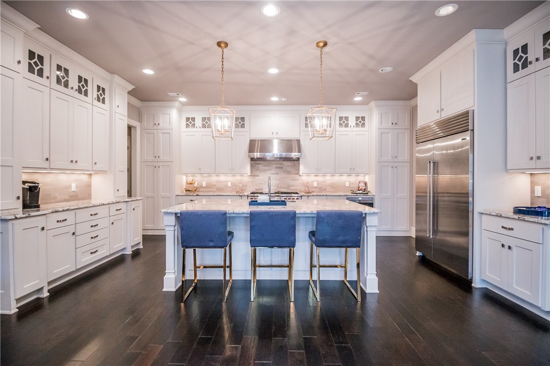 Zoned for both Bentonville and Rogers School Districts!!  High style abounds at this 5 bedroom, 5.5 bathroom estate in the gated Pinnacle subdivision. Beautifully designed, featuring ebony hardwood flooring, designer Contemporary lighting, French doors, gorgeous custom cabinetry, granite countertops throughout and stunning architectural details. Spacious media room featuring wet bar and 110" projector system with Black Diamond Light Rejecting technology. The grounds are graced with lush landscaping and a covered patio for entertaining and relaxing.