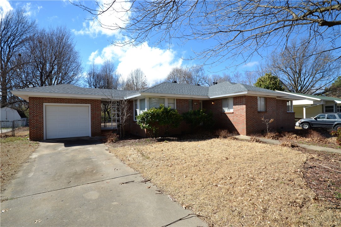 Location is perfect on this home! Central to all of NWA and just minutes from I49! The home features solid hardwood floors that have just been refinished, new paint, wood burning fireplace, large kitchen and utility room!! The backyard is big and large mature trees make the setting really nice!