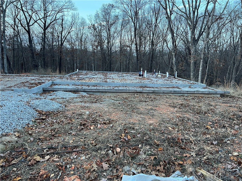 Welcome to the site of your future home! You have a head start because this lot already has the foundation with rough-in plumbing and septic tank on it. It is ready to come to life, and you have the opportunity to make it uniquely yours. With detailed plans, approved septic permits, and a skilled builder at your service, you're ready to build your 2000 square foot dream home.