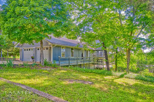 Looking for a home on the lake that is peaceful and serene?  This house could be your dream come true! Home has  2 large decks, split level, with a great floor plan.  This 3 BR 2BA home has 2 BR  up and 1 master BR on lower level with a nice large family room that walks out onto the deck on lake side. Because this home is a tri-level, the stairs are broken up so its not a burden to go up and down!  Outside entrance from outside to lower level. Family room lower level has New flooring. Screened in porch off the kitchen/dining.  Outside you are surrounded by nature! Trees and shade and lake view!  Sit on your choice of decks and enjoy lake living at it's best.