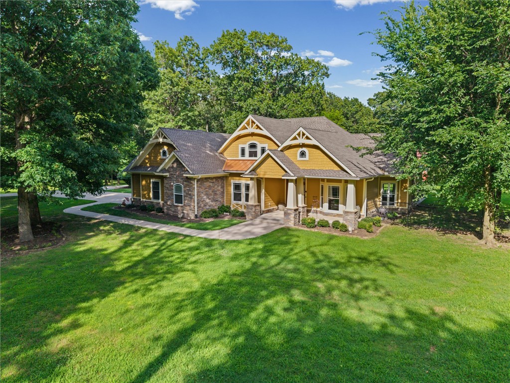 Beautiful 3BR/2BA Craftsman-style home offering 2,495SF on 5.31 park-like acres. This well-maintained property features a spacious floor plan, gas fireplace, tile and engineered hardwood flooring throughout, and covered front and back porches perfect for enjoying the peaceful surroundings. The updated kitchen boasts new granite countertops and a redesigned island (2020), along with a premium Thermador range and dishwasher. Recent updates include a new roof (2024), interior paint (2020), and new glass enclosure in the primary shower (2025). Home is wired for a generator (Honda generator will convey). Outside, you'll find a 2,000SF heated and cooled red iron shop, additional carport, mature trees, open space, and plenty of room to enjoy peaceful country living. Property is priced to sell, below appraised value. Schedule your private showing today and experience everything this exceptional property has to offer!