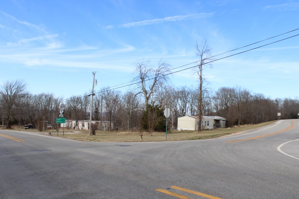 2 Near Level Acres at Junction of Hwy 7 & Hwy 374 - Terrific Location for a business or any type of nightly rentals with great visibility from both highways. Property overlooks the Arkansas Grand Canyon with a view through the trees and includes 2 active water meters and 2 septics, an Iris garden with a large variety of Iris flowers, and a potential spring with a concrete box in place. Property also has 2 older mobile homes that add little or no value, also remains from a concrete block building that burned in the past, and accumulation of numerous miscellaneous items that most buyers will plan to remove. Shown by Appointment Only. See aerial sketch in Documents.