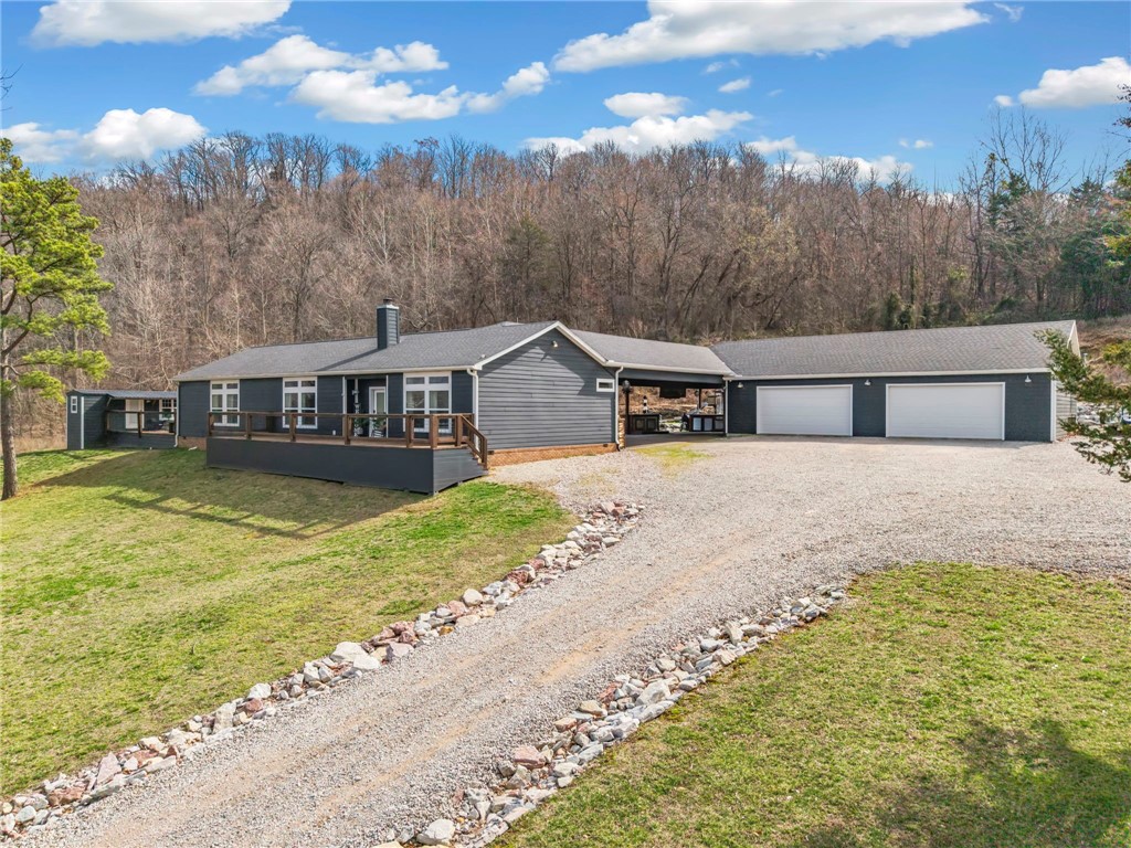 Just 4 minutes from Kingston Square, this 27-acre property feels like a private resort! The 4-bedroom, 2-
bath, 2,220 sqft main home features gorgeous rough-sawn pine floors and plenty of space for family and
guests. Enjoy a detached 30x50 shop with a 12-foot overhang, an attached 30x50 garage, and an RV site
complete with its own electric, water, and septic, ready for a new build. Outdoor entertaining is a dream
with a full outdoor kitchen, bar, fire pit, raised flower beds, playset, and a heated inground gunite pool
with a waterfall. Additional highlights include a cozy 1-bed, 1-bath guest house (240 sqft) and even a
small cave, making this property truly special. This is a modular home, NOT a manufactured home. Please reference the chart if needed.