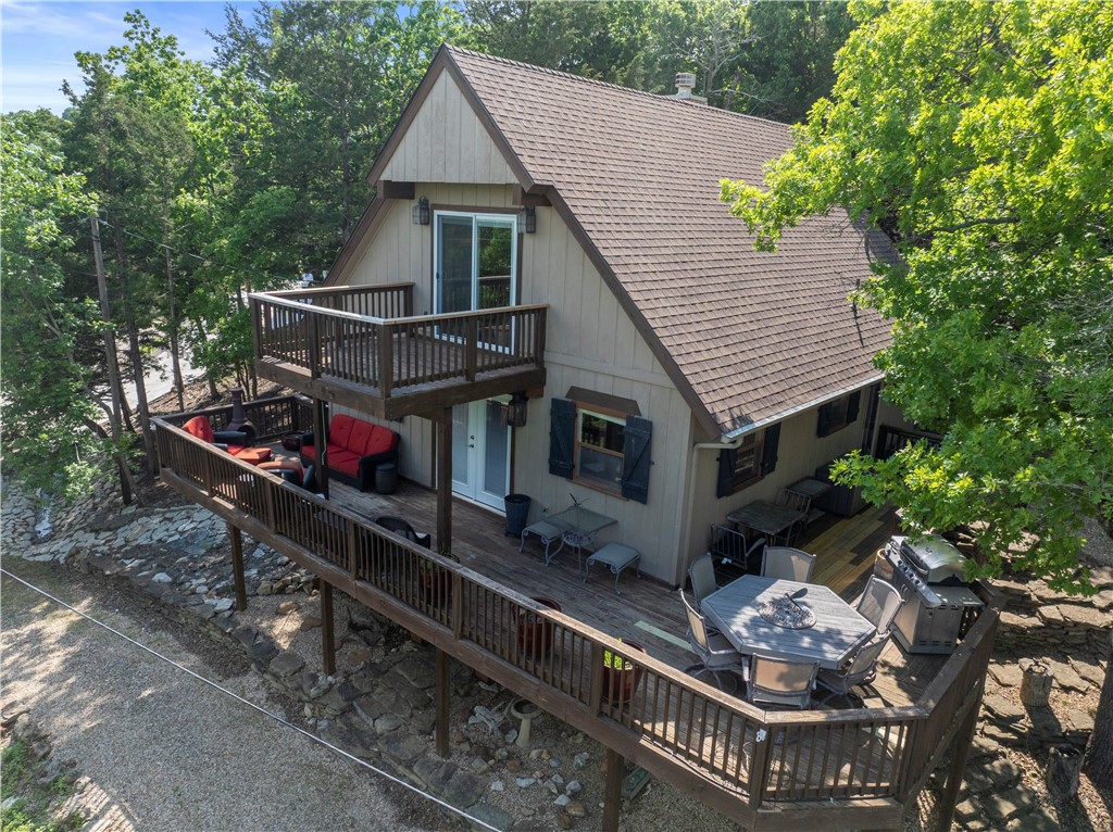 BOAT SLIP INCLUDED + EXTRA LOT!
Lake retreat in Lost Bridge Village offering the ultimate blend of lifestyle, income potential, and flexibility, all just moments from the water. Inside, the home exudes a warm, lodge-inspired feel with exposed wood beams, rich walnut flooring, and wood-look tile throughout. The private top-floor primary suite is a true escape, featuring serene views, a soaking tub, and a walk-in shower. Designed with entertaining in mind, the walk-out basement offers a second living area with a cozy fireplace, game space, and additional sleeping quarters—perfect for hosting guests or maximizing short-term rental income. Enjoy Lost Bridge Village amenities, including a pool, tennis courts, clubhouse, fitness center, and private airstrip—creating a resort-style experience for owners and guests alike.
Recent upgrades include roof and HVAC (approx. 3 years old), offering peace of mind. The extra lot adds rare value and flexibility—ideal for expanding your investment footprint.
This one delivers!