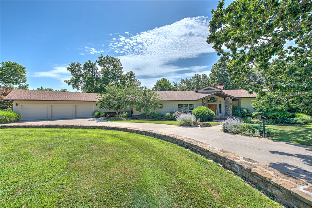 Rare opportunity to own a custom-built contemporary architectural masterpiece set on 30.31 private acres, where exceptional design, refined luxury, breathtaking natural beauty, and an exceptional equestrian lifestyle exist in perfect harmony. Enjoy the serenity of country living just 5 min from Historic Downtown Rogers and less than 15 min from Downtown Bentonville, the Walmart Home Office, and Pinnacle Hills. Dramatic walls of floor-to-ceiling glass, soaring ceilings, and expansive open living spaces define the home's striking architecture. A thoughtfully designed, showstopping chef's kitchen features commercial-grade appliances, butler's pantry, & climate-controlled wine cellar. The private owner's wing offers a secluded retreat with a spa-inspired bath w/ freestanding tub enjoying tranquil views. A gracious formal dining room accommodates 12+ guests, while the outdoor kitchen, office, 5-stall horse barn, riding arena, pipe pens, loafing sheds, riding trails, & spring-fed creek complete this extraordinary estate.