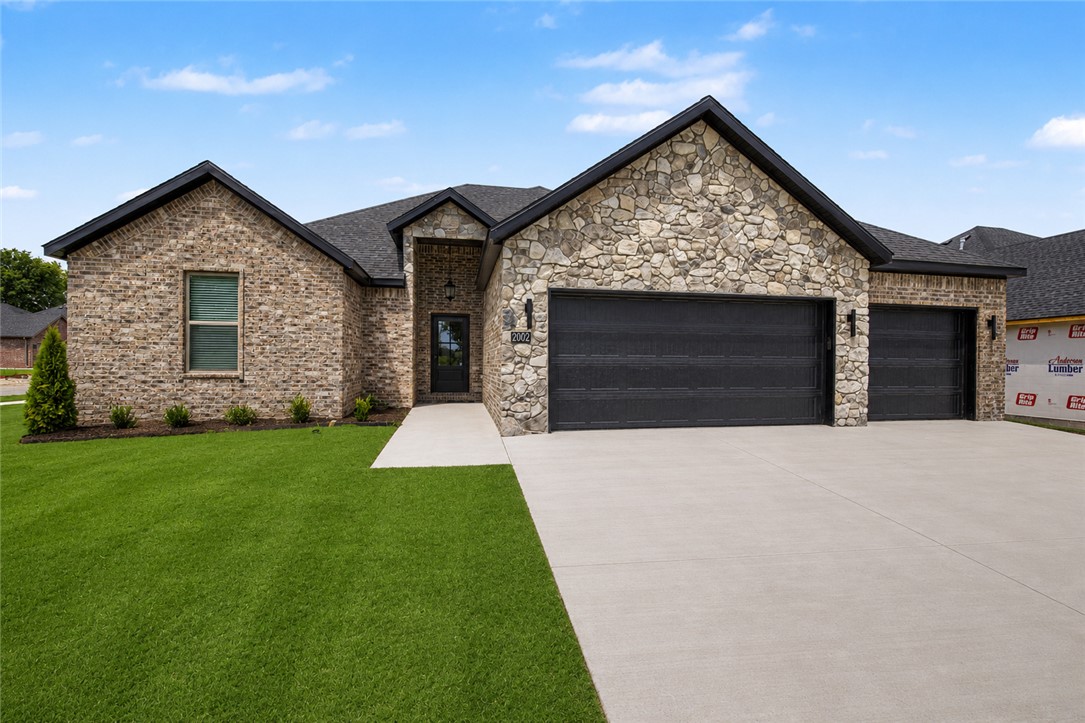 Welcome to this beautiful new construction home in Siloam Springs! This thoughtfully designed home offers a custom interior and exterior design of modern living space with quality finishes throughout. The exterior features classic brick construction, a 3 car garage, & an inviting curb appeal, while inside you’ll find luxury vinyl plank flooring, an open & functional layout, & abundant natural light. The kitchen is equipped with quartz countertops, energy star appliances, eat-in kitchen space, & ample cabinetry while the living area has an electric fireplace & custom built-ins on both sides. Enjoy outdoor living on the patio. Don’t miss the opportunity to own this move-in-ready new construction home in a growing Siloam Springs neighborhood!