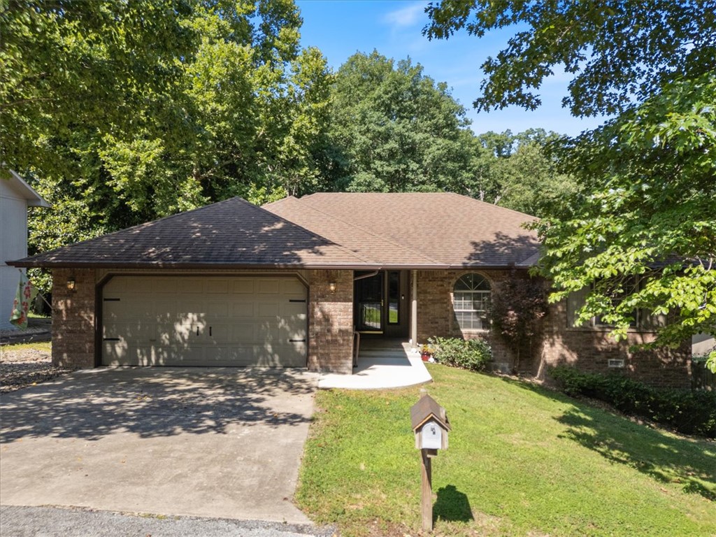 Get ready to fall in love with this beautifully updated home in an unbeatable Bella Vista location! Recent improvements include PVC-free luxury vinyl plank flooring, fresh interior paint, quartz countertops, a farmhouse sink, and a roof replaced in 2020. This thoughtfully designed home features an oversized garage, 2 bedrooms, a dedicated office, and a finished lower-level flex space ideal for a workshop, hobby room, fitness area, or storage. The well-appointed kitchen offers solid wood cabinetry, a generous pantry, and opens to the spacious living room with cathedral ceilings and peaceful wooded views. The owner's suite features a large walk-in shower, two walk-in closets and an additional storage closet.  A covered deck, mature shade trees & place to store toys hidden from street. Tucked away on a quiet cul-de-sac with direct access to the Little Sugar Trail leading to Tanyard Creek. Just minutes from grocery stores, Highway 71, golf, lakes, clubhouses, medical facilities, and everything Bella Vista has to offer.