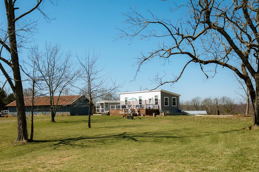 Unique Ozark property on just over an acre featuring two separate dwellings both turnkey, stylish, and cozy. The 600 sq ft manufactured home offers 2 bedrooms, 1 bath, and a 36’ x 10’ deck with peaceful lake views (lake not on property). A 240 sq ft cabin provides additional space for guests or potential rental income. Property also includes an RV hookup for added flexibility. Enjoy a quiet setting just minutes from Pedestal Rocks, Kings Bluff, Falling Water Falls, and the Ozark Highlands Trail, with nearby opportunities for hiking, rock climbing, horseback riding, mountain biking, and ATV trails. Perfect for full-time living, multigenerational use, or short-term rental income