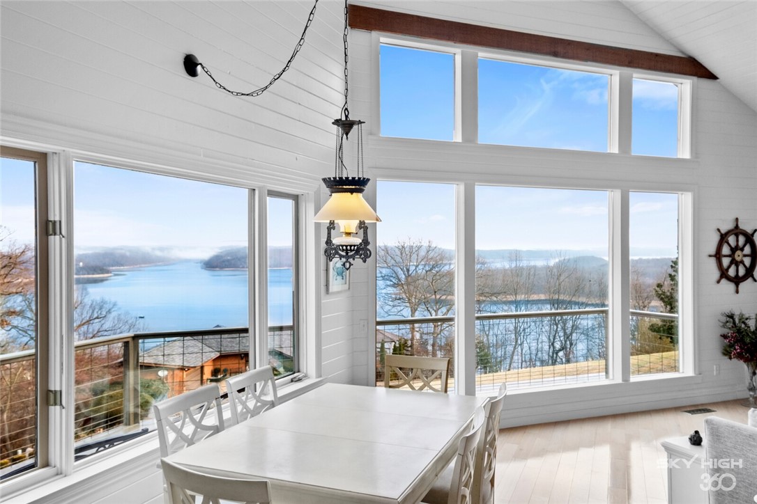 Enjoy panoramic views of Beaver Lake and the Ozark Mountains. The bright, beach-house-like living room features stunning views, deck access, vaulted ceilings, fireplace, and gorgeous wood floors. The kitchen has been completely remodeled with non-porous sea shell countertops imported from Italy, new flooring, cabinets, fixtures, and high-end appliances including double ovens. The luxurious master suite is a calming retreat with stunning views and deck access. The master bath has been completely remodeled with marble flooring and countertops, crystal light fixtures, and a spacious tiled master shower. New windows, paint, flooring, extensive landscaping, and more. Enjoy an abundance of Azaleas, Irises, Hibiscus, Stella lilies, Kanas, & Crêpe Myrtles. 5th bedroom suite possible with the additional ensuite room.Additional bonus room w/wet bar and tons of storage. 3 car garage with separate entrance to the downstairs living area. Less than 5 minutes to Prarie Creek Marina & approximately 10 minutes from downtown Rogers.
