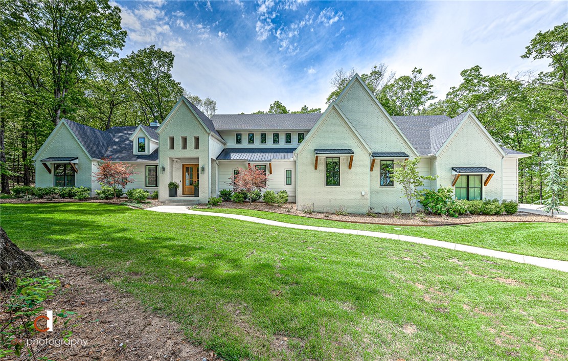 Custom East Fayetteville Modern Farmhouse! Nestled on 8 +/- acres, this home is a designer's dream, & a nature lover's paradise! Inside, experience the coziness of a farmhouse & the joy of an oversized kitchen fit for gatherings around the locally sourced white oak island. Professional appliances, including double oven, ice machine, trash compactor & oversized refrigerator/ freezer. Knotty pine ceiling in kitchen & cathedral beamed family room ceiling. Oversized mudroom with ample storage & a laundry room that dreams are made of! Butler's Pantry with study area & walk-in food pantry allow for organization & storage galore. Five bedrooms, 3.5 baths, w/ Flex Spaces: Art Room & a Playroom/ Media Room with knotty pine cathedral ceiling. Walk out attic for ease of seasonal décor storage. Outside, boasts outdoor living at its best! A twin size patio swing/bed & dining area with TV & fireplace allow for year-round outdoor enjoyment. Outdoor shower is a plus! 40x40 Barn w/ utilities & space for RV. Zoned Vandergriff Elem.