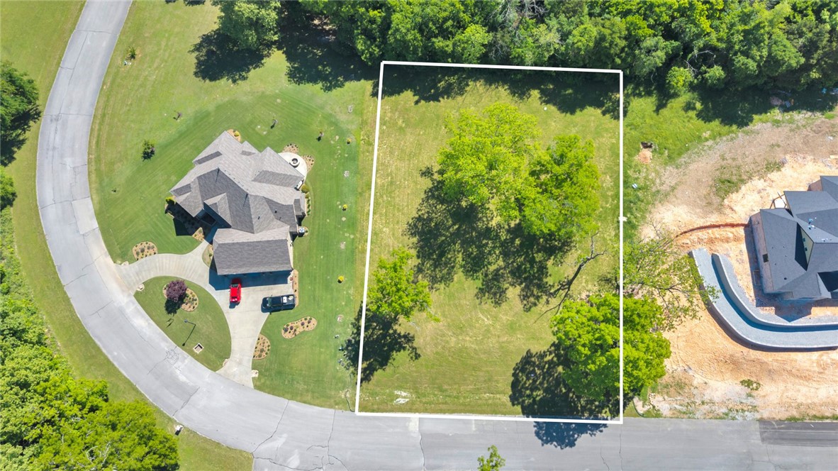 Create the custom home you've always envisioned in the highly sought-after Knolls community of East Fayetteville! This beautiful 1 acre lot features distinctive terrain that provides endless opportunities for a unique & thoughtfully designed residence. Convenient access to electric, water, & natural gas is available at the street. Surrounded by mature scenery & established homes, residents enjoy exceptional neighborhood amenities including a swimming pool, tennis, & pickleball courts, a clubhouse, & scenic walking trails. Don't miss this rare chance to build in one of Fayetteville's premier neighborhoods, where natural beauty & outstanding amenities come together.