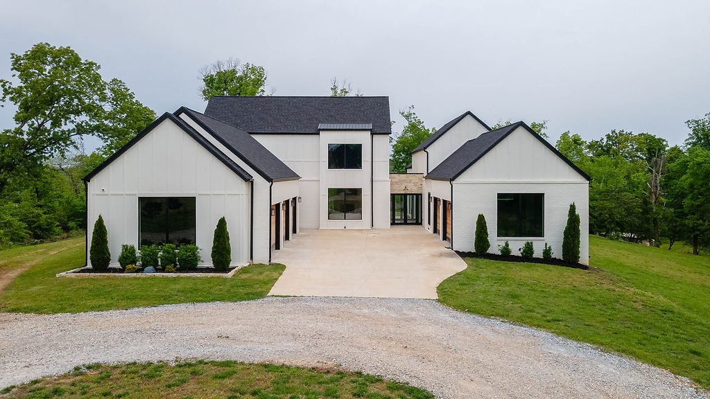 Welcome to 11600 Mill Dam Ct—an elegant modern estate 4-bedroom, 3.5-bath home spanning 5,342 sq ft on 5.6 private acres in the Bentonville School District. Just 7 minutes from XNA Airport, 15 minutes from Pinnacle, or Bentonville square in 20 minutes. This home offers both seclusion and convenience. Highlights include a spacious, open interior with refined finishes, a luxurious primary suite with LED fireplaces, large tiled shower, and a custom walk-in closet. Additional features include a dedicated office and library with walls of bookshelves, a saferoom integrated with the laundry area, a gourmet kitchen with a Mercury induction range and built-in refrigerator and freezer, and a walk-in pantry with a second fridge and icemaker. Upstairs boasts two bedrooms with a Jack-and-Jill bath and a versatile 23x19 bonus room also a walkout deck from 2nd floor to enjoy. The property also offers room for future additions like a pool and or plenty space to build a shop. Take the next steps to make this your home.