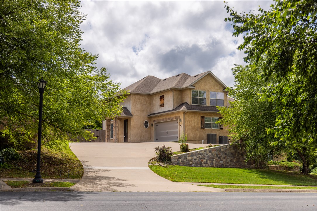 Situated in the Creekstone neighborhood, where homes rarely become available, this well-maintained residence offers the perfect balance of privacy, comfort, and convenience. Ideally located with easy access to I-49 and 8 minutes to the Walmart Home Office, the home is just minutes from the amenities of both Bentonville and Bella Vista, including the Little Sugar Creek restoration project. Inside, soaring ceilings accented by wood beams create a welcoming and open atmosphere filled with natural light. The spacious primary suite, 2 additional bedrooms and a full bathroom are located upstairs. A long driveway enhances the home's privacy and leads to a well-maintained property featuring new carpet and interior paint. The fenced and spacious backyard offers a concrete patio, creating an ideal space for entertaining or relaxing. Combining a sought-after location and a setting that feels tucked away while remaining connected to everything Northwest Arkansas has to offer, this is a rare opportunity in Creekstone.