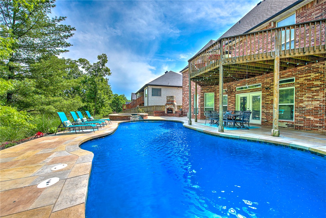Estate property with pool conveniently located near Downtown Bentonville, Walmart Home Office, Crystal Bridges Museum, top-rated schools, shopping, dining, and quick I-49 access. This 5 bedroom, 4 bathroom home offers a fully finished walk-out basement, multiple living areas, and a private backyard retreat featuring a heated in-ground pool, expansive patio spaces and a fenced yard designed for entertaining and outdoor living. The layout design provides hardwood flooring, abundant natural light, a spacious kitchen, luxurious primary suite, game room, exercise room and flexible spaces ideal for remote work, guests, or multigenerational living. The backyard oasis is a rare find, offering privacy, mature landscaping, and resort-style pool living just minutes from the city’s business district, trails, parks, and cultural attractions. Perfect for buyers relocating to Northwest Arkansas or searching for a luxury Bentonville home with a pool, finished basement, and convenient access to everything the area has to offer.