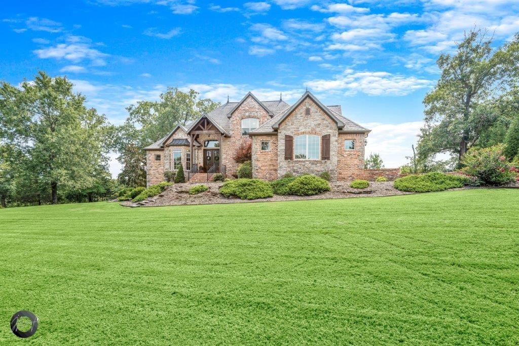 Stunning Lakeway Estate Home with Boat Slip on Community Dock! 2.11 Acres w/ private wooded setting. Move in ready! Wood flooring throughout living areas, new carpet & touch up paint. Office w/walk in closet off entry. Formal dining has built in cabinet storage and flows into kitchen. Grand living room has 22ft vaulted ceiling w/beams, floor to ceiling stone fireplace, 2 French doors to deck, large windows. Spacious eat-in kitchen is open to living. Kitchen boasts abundant cooking space w/large island, counter bar, pantry & much more. Electric cooktop can be converted to gas. Guest bed w/attached bath on main. Large master suite w/ WIC, whirlpool tub & WIS. Upstairs there is 2 guest beds w/J&J bath. Huge media room has balcony, large wet bar space & half bath. Gorgeous outdoor living space with large deck, covered space has stone fireplace. Oversized 3 car garage. Laundry room w/built in storage. This is a MUST SEE!