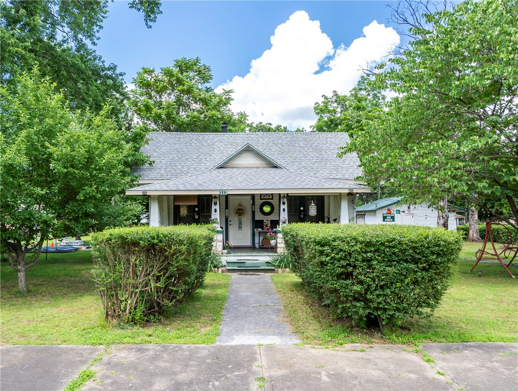 Nice two story home  on a nice landscaped lot.  Has wood floors and carpeted  bedroom upstairs.  There is a bedroom up and bath room and master bedroom with bath down stairs. There is a library area and a craft room .  Has a nice size kitchen and dining area and lots of storage areas.  Garage converted to a he shed or a office.   Roof is 2 years old.  This home is not far from the Missouri line and close to Gravette.  Close to the city park.  Nice little country town.  If you don't like the big town life this is what you would be looking for.