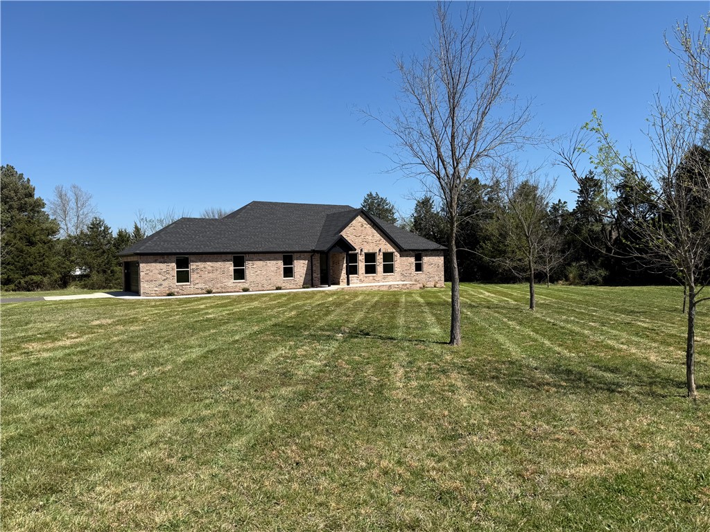 Tucked away on a quiet street, close to schools & shopping is a beautiful, all brick, brand new home, just waiting to be called your own! Large 1.17 acre lot and 2,555 square feet, plenty of space to stretch out! A well laid out floor plan maximizes space & allows for plenty of storage with walk-in closets and nine foot ceilings. Durable, easy maintenance finishes such as quartz countertops, grout free shower walls and luxury vinyl plank flooring take the worries out of maintenance & cleaning while energy efficient appliances & insulation save energy costs. Thoughtful details make this home sparkle, such as the vaulted, wood beamed ceiling & glass front fireplace in the living room, trim details, shaker style cabinets, kitchen pantry and large amount of natural light from the many windows. Oversized garage with epoxy painted floor allows for workbenches as well as opening car doors without worry.  Seller agrees to pay up to $5,000 of buyer closing costs and prepaids at closing!