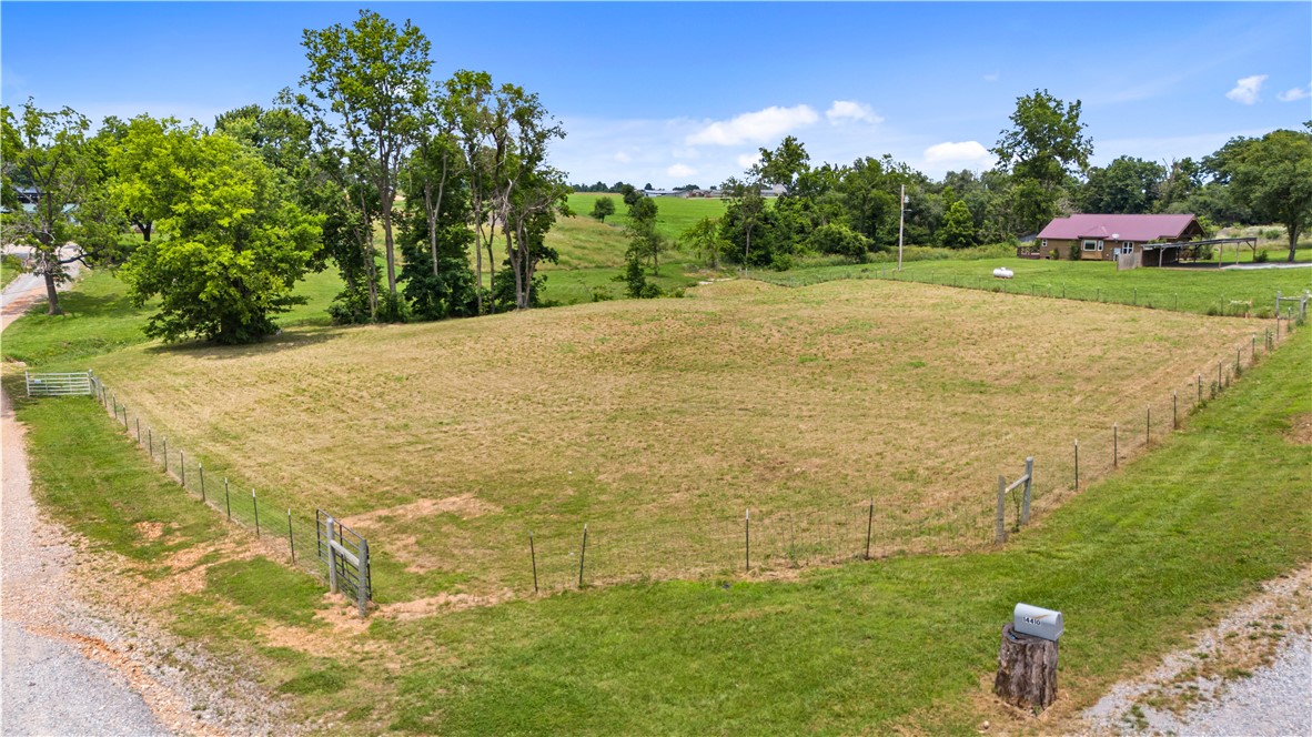 Prime 1.61 acre commercial/development tract on AR Hwy 102 with outstanding visibility and major highway frontage. This cleared, open parcel offers an exceptional view, natural spring that feeds the stream/creek, a pond and no deed restrictions, giving buyers flexibility for commercial or mixed use ideas. Electric is available at the street, rural water and the property is already surveyed. Located just minutes from Gravette amenities yet outside city limits, it’s truly the most in town, out of town parcel you’ll find. Positioned near the proposed ARDOT bypass corridor, this site sits directly in the path of future growth.