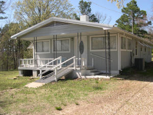 Right in the heart of all the outdoor fun you could want. This home is just 7 miles south of Jasper. Very near the scenic Arkansas Grand Canyon. Only minutes to the Ozark National Forest and the Buffalo National River. It sits off Hwy 7 enough that you can enjoy some privacy but close enough that you can easily bring motorcycles to the house. This is a vacation home waiting for you! It just needs a little TLC. This home is being sold ''AS-IS'' only and will not qualify for a USDA-RD, VA or FHA loan. The seller requires $2,000 non-refundable deposit three business days after an accepted contract that will apply to the purchase price. Only full price offers will be accepted.