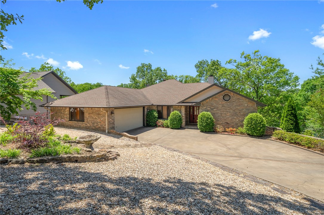 Gorgeous landscaped lake front home with private boat dock! Nicely updated. Living room has vaulted ceiling, remote controlled gas fireplace refaced with stone, & tall windows for plenty of natural light. Large sunroom off living room. Kitchen has matching appliances, eat-in, under-cabinet lighting, tiled backsplash, & immediate hot water with tankless hot water heater at sink. Large formal dining room. Spacious master has access to sunroom, jetted tub, separate shower, dual vanity, & large walk-in closet. Guest room has bath & large closet. Laundry room with sink. Huge downstairs media room & bar area with kitchenette & lots of storage. Awesome workshop downstairs with epoxy floor, built-in shelving & work bench, plenty of outlets, & sink. 1 bedroom, bath & an office downstairs. Garage has epoxy floor & room for golf cart. 2 levels of deck in back with stair access to both. Steps down to the private boat dock. New geothermal furnace & water heater. New lake-sourced irrigation system. Come see this wonderful home!