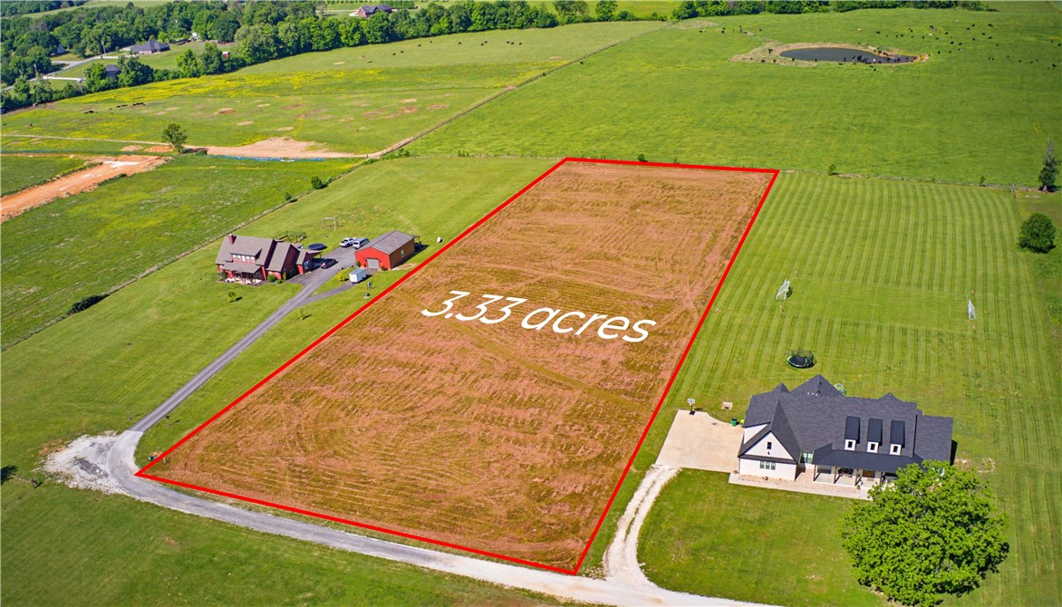 3.33 level acres located in the Farmington School District. Mostly open and usable land with multiple potential building sites. Property offers space for a custom home, shop, garden, or additional outdoor improvements. Conveniently located near Farmington and Fayetteville with easy access to schools, shopping, dining, and major commuter routes. Located near Randall G. Lynch Middle School in an area with ongoing residential development. Rare opportunity for acreage in Northwest Arkansas with both privacy and accessibility.