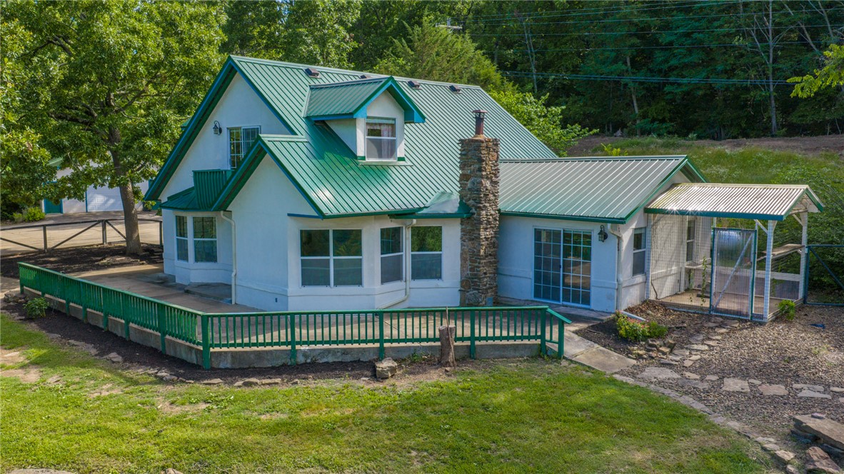Escape to your own private retreat on 7.28 acres in the West Fork! This well-maintained 3-bedroom, 2.5-bath home offers comfortable living space, perfectly situated with approx. 1- acre cleared and the remaining acreage wooded for privacy, recreation, and wildlife viewing. Home features spacious living areas, a functional floor plan, and a 3-car garage with plenty of room for vehicles, equipment, and storage. Step outside and enjoy  a heated saltwater in-ground pool—perfect for relaxing or entertaining year-round. Need additional workspace? The impressive 700-square-foot detached shop provides endless possibilities for hobbies, projects, storage, or a home-based business. Enjoy the peace and tranquility of country living while remaining just a short drive from Fayetteville and all that NWA has to offer. Whether you're looking for a private homestead, a place to entertain family and friends, or simply room to roam, this property delivers the best of both worlds.