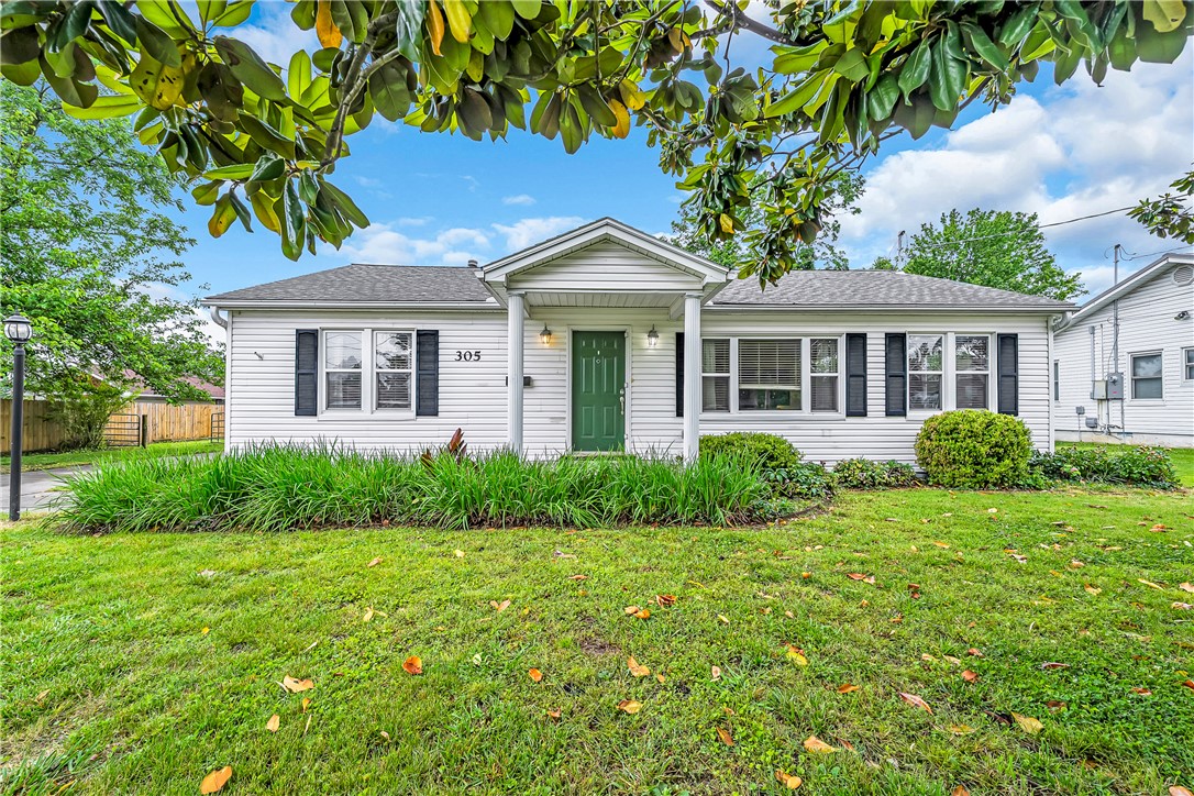 Welcome to 305 S Dixieland Road — a clean, solid ranch home on 0.76 acres in the heart of Rogers. Built in 1955 and updated in the early 2000s, this 3-bedroom, 1-bath home offers timeless character with real staying power. The living room features beautiful original hardwood floors, and the generously sized kitchen is ready for everyday living. Hardwoods also run beneath the carpet in the hallway and bedrooms — a bonus for the next owner. The large bathroom, roomy bedrooms, and functional layout make this home immediately livable. Out back, a covered enclosed porch is ready to become your favorite sunroom with a few new windows or screens. The detached garage adds great storage and workspace. Best of all, you're right along the Poplar Street Parkway — cycling to downtown Rogers is a breeze. Minutes from Rogers' shopping district, dining, parks, hospitals, and top schools. No POA, huge lot, solid bones throughout.