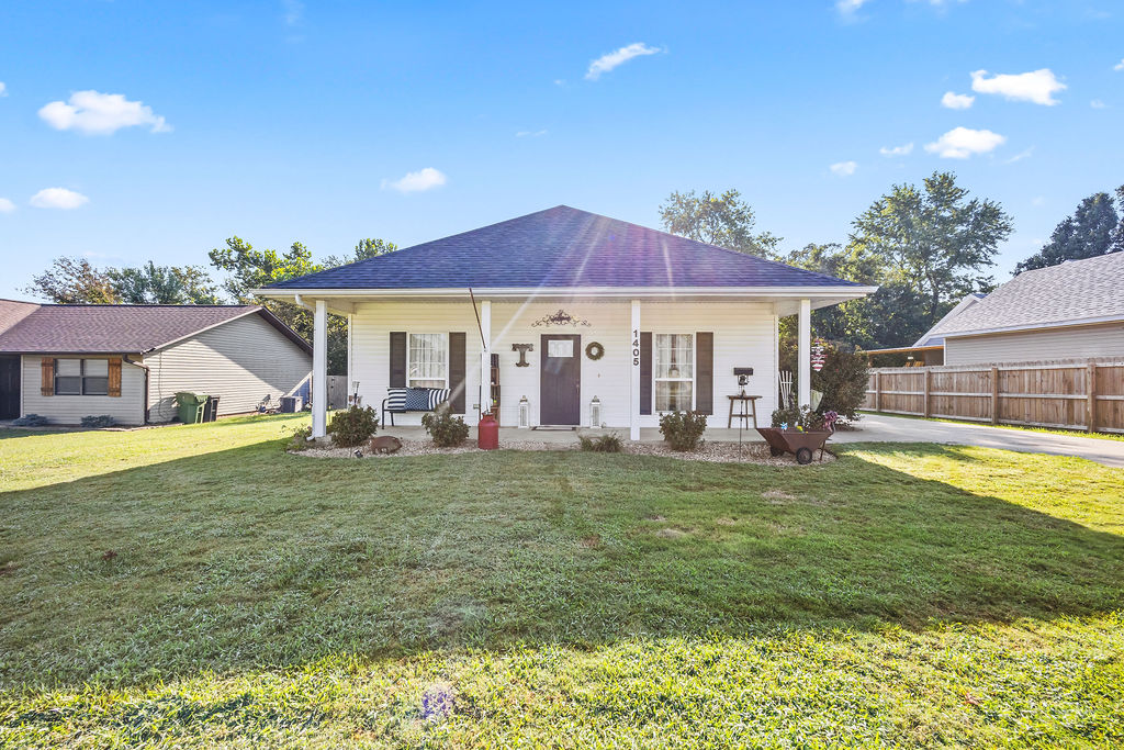Welcome to 1405 S. 5th Street! This cute little home was built in 2006 & sits on a nice flat lot that is located directly across the street from the Rogers Heritage High School, making it a prime location! Downtown Rogers is less than a mile away making it super close to good food & entertainment. The Railyard Bike Park is a 5 min bike ride away & the bike trails are also super close. The exterior of the home has great curb appeal w/nice landscaping, a long driveway, & a good sized detached 2 car garage. New roof in 2025, a newer natural gas water heater, & the HVAC system was just serviced. From the outside, the home may look small but walk inside & find a floorplan that used every inch of square footage. Inside the home offers 3 cozy bedrooms w/good sized closets, a separate dining room, a large kitchen, & a nice living room to relax after a hard days work. Oh yeah, the backyard has a huge deck for entertaining & a small fenced in area for the dogs! With some updated flooring & paint, this house will be perfect!