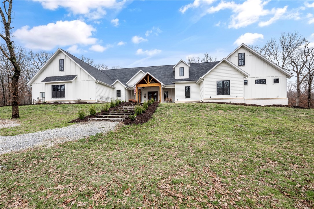 Beautiful Custom-Built Modern Inspired Farmhouse on 6 Peaceful Acres!  Come home to quiet living surrounded by nature with raised garden beds, birds, fruit trees, a chicken coop, with a huge heated covered back porch to sit and enjoy it all from!  Spacious open one level home with hard-to-find attached mother-in-law/guest suite.  Stunning kitchen with large 12-foot island, double ovens, two pantries, and a second prep kitchen area.  Master bedroom with spa like bath featuring steam shower, and large walk-in closet.  Three additional guest rooms, one featuring charming built-in bunk beds.  Separate guest/mother-in-law quarters features kitchenette, bedroom, and bath. Oversized 4 car garage featuring hydraulic lift in garage to assist with storing things in attic! Other features include in-house storm shelter, secret in-home access to attic, home wired for generator, Tesla charging station. So much to list!  So come and see for yourself and don’t miss out on this amazing place to call home!