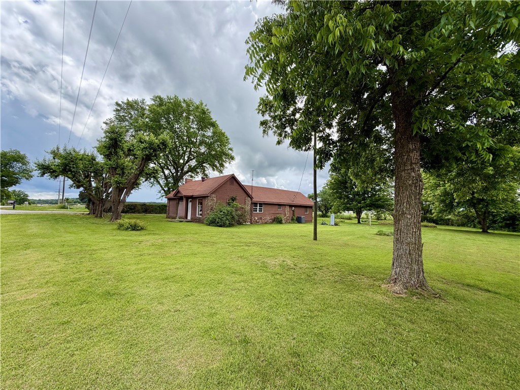 Charming 1,400 sq. ft. country home featuring 2 bedrooms, 1 bathroom, and a bonus room. This cozy property offers beautiful wood floors, a wood-burning stove, and convenient indoor wood storage built right into the wall — no need to store firewood outside. Situated on three flat acres just outside the city limits, the property also includes a shop/garage and is located just minutes from Pea Ridge National Military Park. Whether you’re looking for a peaceful country retreat with acreage or a property with development potential, this one offers endless possibilities. Shop has electric, as well.