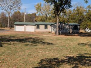 Beautifully updated 1,586 sq. ft. mobile home with a permanent foundation, located in the desirable Pottsville School District. This 3-bedroom 2-bathroom home sits on 4.48 scenic acres with a serene pond. The main house is plumbed for a Hardy wood stove, providing an efficient heating option for the entire house. It also includes a 2-car garage and an additional carport. Additionally, the property features a charming 1- bedroom, 1- bathroom guest house with its own 2-car carport overlooking the pond. A separate shop with an enclosed storage shed area offers ample storage or workspace, making this property ideal for those who value both comfort and functionality.