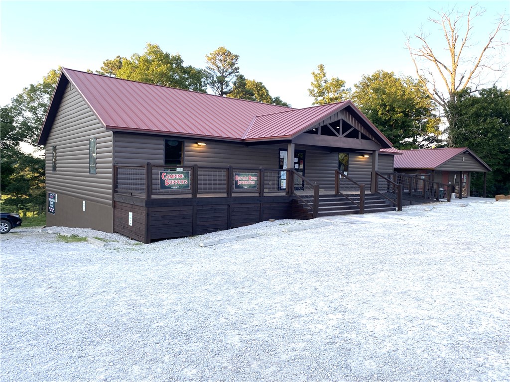 Strategically located at the junction of Hwy 74 & Kyles Landing Rd (5 mi from Jasper) near Kyles Landing Access Point/Campground (2.6 mi) & Triple Falls Waterfall of the Buffalo National River. High traffic count location. Located between Jasper and Ponca and near the Ozark National Forest. Located on 2 ac. The main bldg features 1600SF retail space, 800SF offices/restrooms, 2400SF unfinished basement (with 400SF finished living quarters),1200 SF of decks/porch, 400 amp underground service to the building, Two-5 ton and One-3 ton HVAC, Two-1000 gal septic tanks w/600' of lateral lines. Property includes Bathroom/Coin operated shower house (24 hr access), 1800SF Maint Shop and Koolaire 300 lb ice maker. Business property  aluminum Elk Statue and retail inventory. This listing does not include the canoe rental and inventory associated with the canoe rental (canoes, rafts, kayaks, paddles, life vest, vehicles, trailers). The canoe rental (with the real property in this listing) is listed as MLS#1312587.