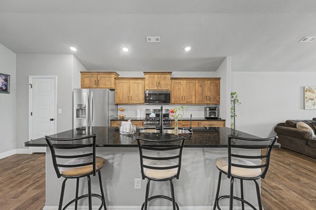 PRICED BELOW MARKET VALUE FOR A QUICK SALE! This all brick Schuber Mitchell build is only 3 years old with beautiful wood tile flooring throughout, carpet in bedrooms. The open floor plan is great for entertaining with an eat-in kitchen space, beautiful black granite countertops and island, along with gas stove, pantry, and tons of cabinet space. Walk in laundry room, split floor plan and quaint backyard setting. This community has two dog parks! One for large dogs and one for the littles. Come and see this clean, spacious, well maintained, like new home! Just 2.5 miles from NWA National Airport, this fully fenced, corner lot home has privacy and seclusion just minutes from everything Benton County has to offer. Visit ardot.gov for details regarding the future North/South 4 lane road plan for this area, bringing access to amenities right near you! With confirmed plans by the end of this year, and completion in 5, now is the time to buy in one of the lowest priced new construction areas in Benton County.
