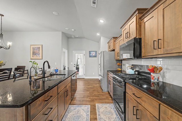 PRICED BELOW MARKET VALUE FOR A QUICK SALE! This all brick Schuber Mitchell build is only 3 years old with beautiful wood tile flooring throughout, carpet in bedrooms. The open floor plan is great for entertaining with an eat-in kitchen space, beautiful black granite countertops and island, along with gas stove, pantry, and tons of cabinet space. Walk in laundry room, split floor plan and quaint backyard setting. This community has two dog parks! One for large dogs and one for the littles. Come and see this clean, spacious, well maintained, like new home! Just 2.5 miles from NWA National Airport, this fully fenced, corner lot home has privacy and seclusion just minutes from everything Benton County has to offer. Visit ardot.gov for details regarding the future North/South 4 lane road plan for this area, bringing access to amenities right near you! With confirmed plans by the end of this year, and completion in 5, now is the time to buy in one of the lowest priced new construction areas in Benton County.