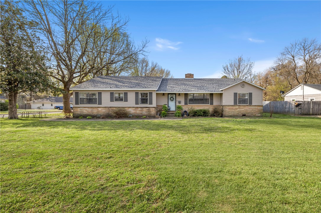 Step into timeless charm and everyday comfort in this established home set on a spacious corner lot. Perfectly located within walking distance to the high school, library, and park, this property offers true convenience.  Inside, you’ll find a generous 4-bedroom layout with two distinct living spaces. One living area features a unique sunken design with built-ins that add character and function. The kitchen is a standout with abundant cabinetry and an oversized walk-in pantry, making storage and organization effortless. The large utility room is designed with daily life in mind, offering a built-in desk area, and a convenient drop zone for shoes and bags. A dedicated office provides a quiet and practical work-from-home solution. The primary en suite includes dual vanities a tiled shower and a relaxing whirlpool tub. Recent updates include a brand new roof in 2025, giving peace of mind for years to come. Rounding out the property is a 21x14 attached workshop—ideal for hobbies, storage, or projects of any kind.