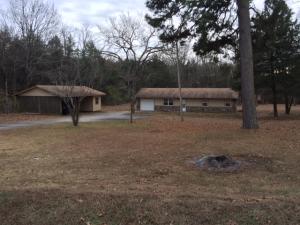 Very Clean home. Ceramic tile throughout. Central heat and air. City water. concrete drive with water drain and gutters. Newer double pane windows and plantation blinds. Several outbuildings. Single garage Plus detached double carport and storage room. Lot is gently sloping mostly cleared.