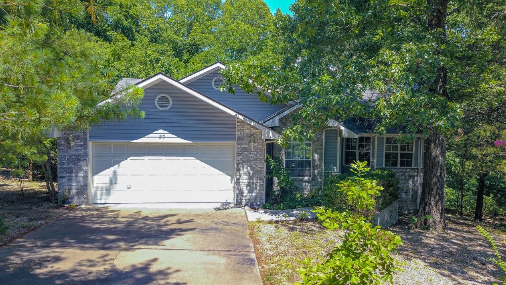 Nestled on a private lot in both Bentonville & Gravette school districts, this 2”x6” stud constructed 3-bed, 2-bath home offers a peaceful retreat to enjoy the beauty of nature while benefiting from energy efficiency & a low-maintenance rock yard. Inside, warm oak flooring is complemented by tile in the wet areas & fresh interior paint for a clean, updated feel. The functional floor plan features an eat-in kitchen, a separate dining room, & a spacious 13' x 23' bonus room on the lower level—perfect for a home office, hobby room, gym, or 2nd living area. Step outside from your primary bedroom or kitchen to a 10' x 22' covered deck overlooking the private backyard & wooded views. Major updates include the roof, siding, garbage disposal, heating system & hot water heater, all replaced approximately 10 years ago. Located less than 0.17 miles from The Beach at Lake Avalon, Lago Vista Spur & Bamboozled Trails, this home combines easy access to outdoor recreation with the tranquility of a secluded retreat.