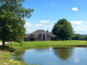 WELCOME HOME TO THE RANCH, 237 Acres of beautiful pastureland with good fencing. cross fenced 8 times, 5 ponds, 3 creeks and one unbelievable view! The Custom built home offers private living with luxurious amenities. 4 bedroom, 3 bathroom, formal dining room, custom office with arched windows. The sunken living-room centers the home with a large fireplace bookshelves and tall ceilings. The Chef's going to be happy in this kitchen with it's own breakfast nook overlooking the brick covered patio and built in hot tub overlooking your beautiful land. The lawn is manicured and fenced with 72 head sprinkler system. Horse and Cattle barns a hay barn too. Barns have electric and water, cattle scale, iron railings, round pen. New Geothermal system make utilities low. Hay pastures separate fenced.