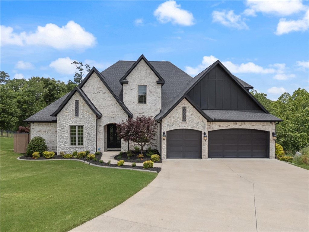 A distinguished custom-built estate in Woods Creek, one of Bentonville’s most coveted enclaves. This pre-inspected 4,872 SF residence rests on .81 wooded acres, offering exceptional privacy while remaining bikeable to Walmart’s New Home Office, Downtown Bentonville, premier MTB trails, and easy I-49 access. This thoughtfully curated floorplan offers 5 bedrooms, 4 full baths and 2 half baths, including a main-level primary retreat with private deck access, spa-inspired bath, and expansive dressing closet. Two additional main-level en-suite bedrooms, executive office, formal dining, and a chef’s kitchen with oversized island, double ovens, gas cooktop, and walk-in pantry create effortless daily function. The upper level features guest quarters, additional bedroom, and an expansive media salon flanked by a vino vault and private flex retreat. Surround sound, central vac, zoned smart climate control, covered outdoor kitchen, and 3-car garage. Furnishings negotiable. Complete due diligence package available.