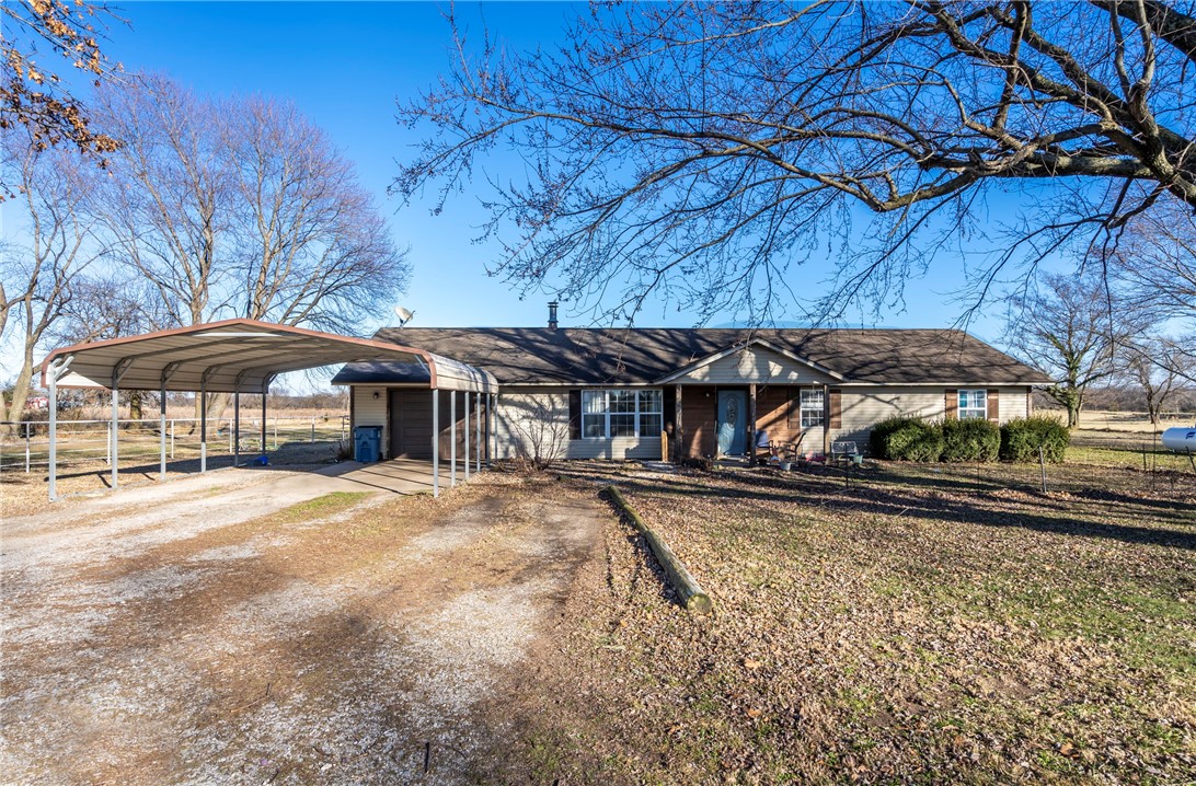 Check out this Charming Country Home on 5.77 acres with a 40x60 Barn, a lean to, horse stalls, fencing and room to roam! 3 Bed 2 Bath home with level acreage and a rural living lifestyle. The home offers a comfortable living space featuring a wood burning fireplace, solid wood kitchen cabinets, pantry, window over kitchen sink that looks out over the property, propane stove (new 2024), propane hot water heater (new 2025), and recent hvac updates include new air in 2025 & new heat in 2020. The land is fully fenced with wire & pipe fencing making it ideal for livestock or horses. Additional features include a one car garage, two car carport & a 2021 above ground pool that conveys. Has maintenance free vinyl siding, septic, Highfill City Water & trash service, along with Walmart delivery availability giving you the best of country living with modern convenience. If you’ve been searching for land, a barn and room to spread out, this one checks all the boxes!
