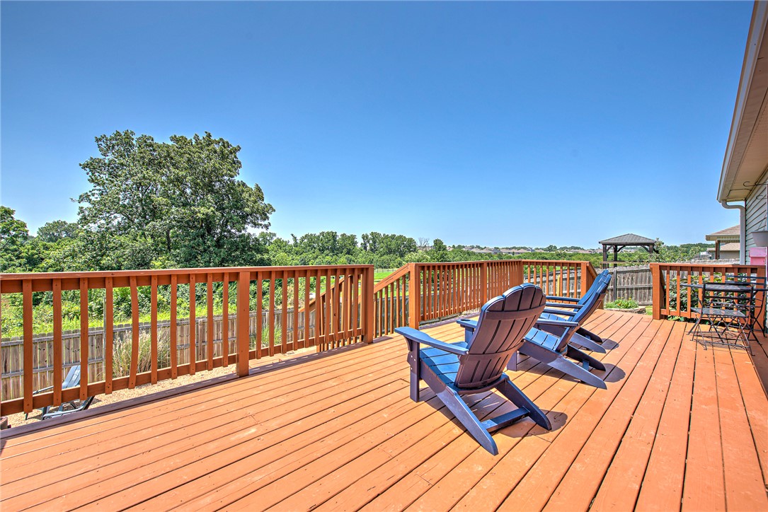A spacious deck and thoughtfully designed split-bedroom floor plan make this Lakewood home an easy choice for comfortable everyday living and entertaining. Whether you're hosting friends, grilling outdoors, or simply unwinding after a long day, the expansive deck extends your living space into the outdoors. The backyard gate provides direct access to the scenic trails just behind the home, making it easy to enjoy walks, runs, or bike rides right from your backyard. Inside, the open living room offers plenty of space to gather, while the kitchen features generous counter space, a large center island, an eat-in dining area, and abundant storage to keep everything within reach. The private split-bedroom layout offers added separation between the primary suite and secondary bedrooms for enhanced comfort. Ideally located near parks, shopping, dining, and schools, this home combines space, convenience, and a location you'll love.
