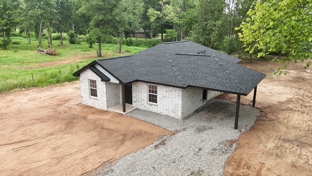 Another beautiful build by Herrera's Custom Homes INC. This Brand New 3 bed 2 bath 1333 sft brick home sits close to schools and shopping on a spacious, cleared, 0.60 acre, surveyed lot. Custom built cabinets, electric fireplace, LED lighting, tile showers, luxury waterproof vinyl flooring, quartz countertops, modern light fixtures, Frigidaire stainless steel kitchen appliances, garbage disposal, stainless steel farm style sink, eat in kitchen, center island with bar, covered porch, 1 car carport, large laundry room! You just have to see this one in person! This wont last long so call for your private showing today!