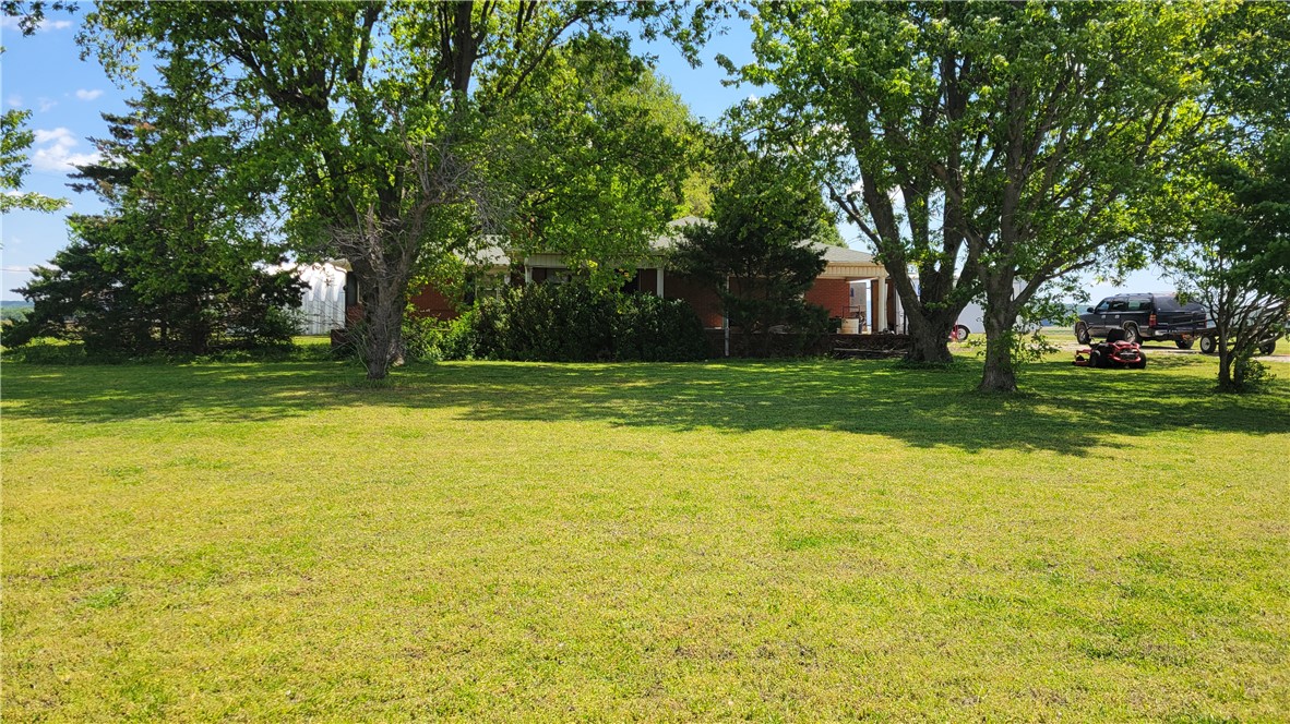 Charming brick home with solid bones situated on 1.06 acres of level, open land offering endless possibilities. This well-built property features a cozy wood-burning fireplace in the large living room. The outdoor space is perfect for gardening, recreation, or future improvements, and gives the peaceful feel of country living. With a strong structure and timeless brick exterior, this home is ready for your personal touch to make it truly your own.