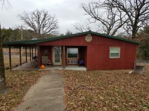 Beautiful 2 bedroom, 1 bath cabin with all the latest luxuries: granite counter tops, hickory cabinets, glass & tile shower. Matching storage building includes a clean and dry cellar / storm shelter. Front and back yard are fenced, the remaining acreage is pasture with lots of highway frontage. Call for a show today!