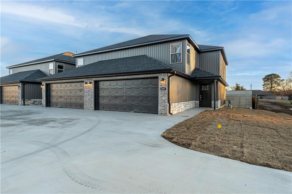 Quality 2024-built fully-furnished townhome located in the heart of Gentry, offering the perfect blend of comfort, style, and convenience. The spacious floor plan features a welcoming living room with a beautiful fireplace, creating a warm and inviting atmosphere. The open-concept kitchen and living area are ideal for entertaining guests or spending quality time with family while preparing meals. A large window above the kitchen sink fills the space with natural light. Upstairs, you'll find three generously sized bedrooms and two full bathrooms. The primary suite features a spacious en-suite bathroom and a large walk-in closet, providing both comfort and functionality. Conveniently located just minutes from Gentry schools and adjacent to the new ballfields, this townhome offers an exceptional location with easy access to local amenities and recreation.