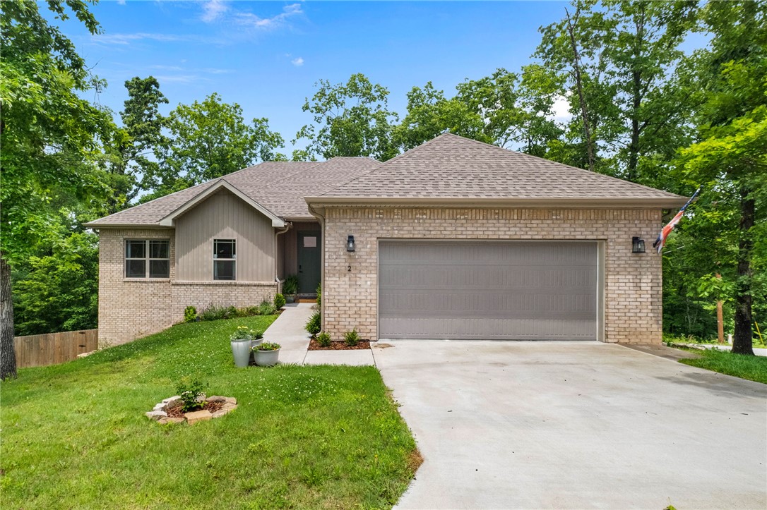 Welcome to this beautifully maintained 2023-built home, perfectly positioned for those who love both adventure and convenience! Nestled on a spacious corner lot with mature trees, a fully fenced backyard, and beautiful landscaping, you'll have incredibly easy access to the Back 40 Trail, including Tunnel Vision Trail, without having to navigate busy roads. This location is hard to beat, just minutes from the new OZ Trails Bike Park and Bike Lift, Lake Windsor, and some of Bella Vista's best outdoor amenities! Inside, you'll find 3 bedrooms plus a versatile office/flex space, a spacious living area filled with gorgeous natural light, and stylish finishes throughout, including granite countertops, a chic tile backsplash, under-cabinet lighting, luxury laminate flooring, and thoughtful details that make this home truly move-in ready. Enjoy the best of Northwest Arkansas, with Downtown Bentonville, the Walmart Home Office, shopping, and dining just a short drive away!